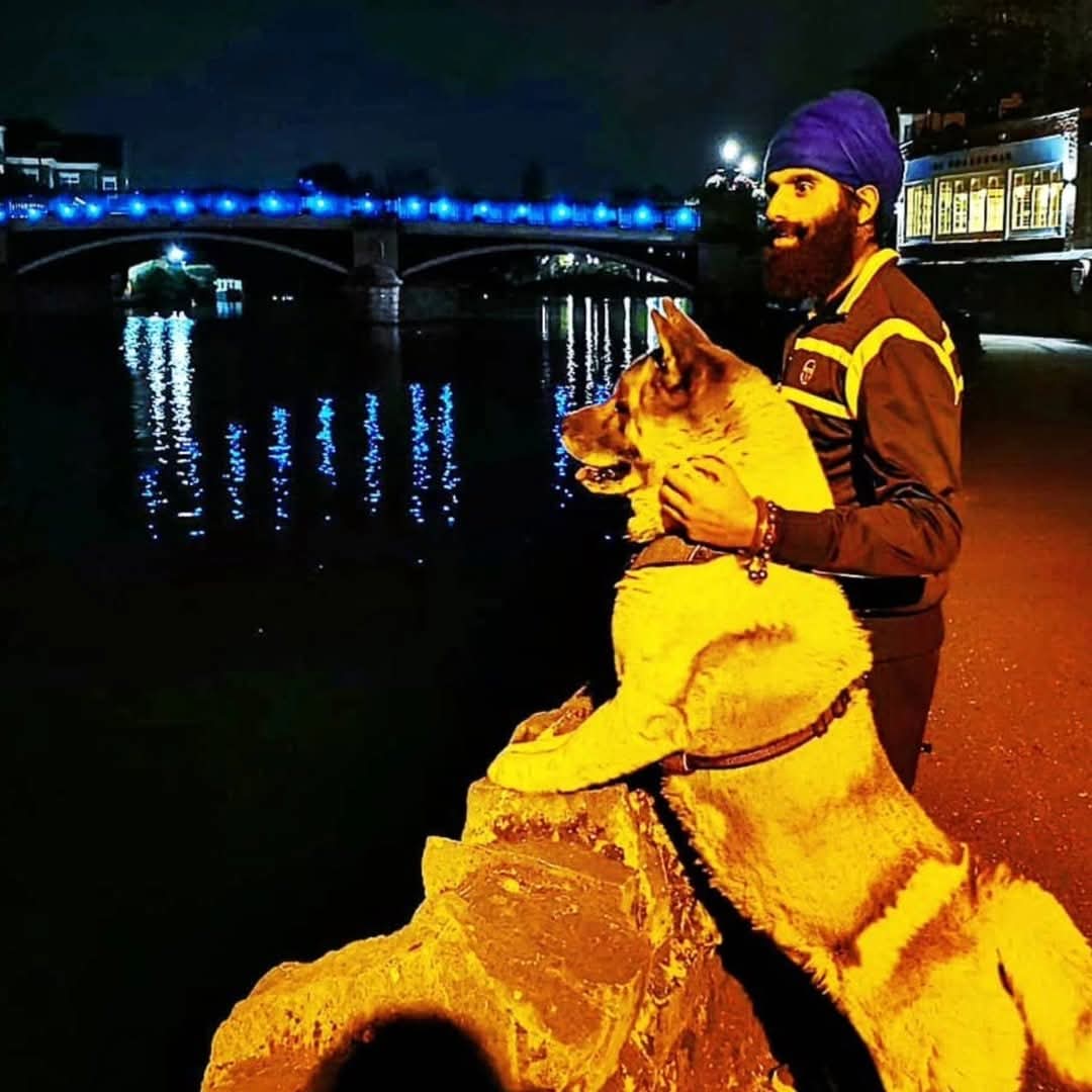 Karan Singh Bains with his dog beside the river